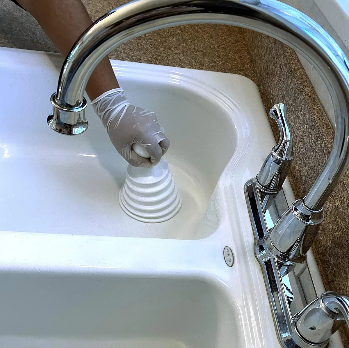 A white Mighty Tiny over a bathroom sink drain