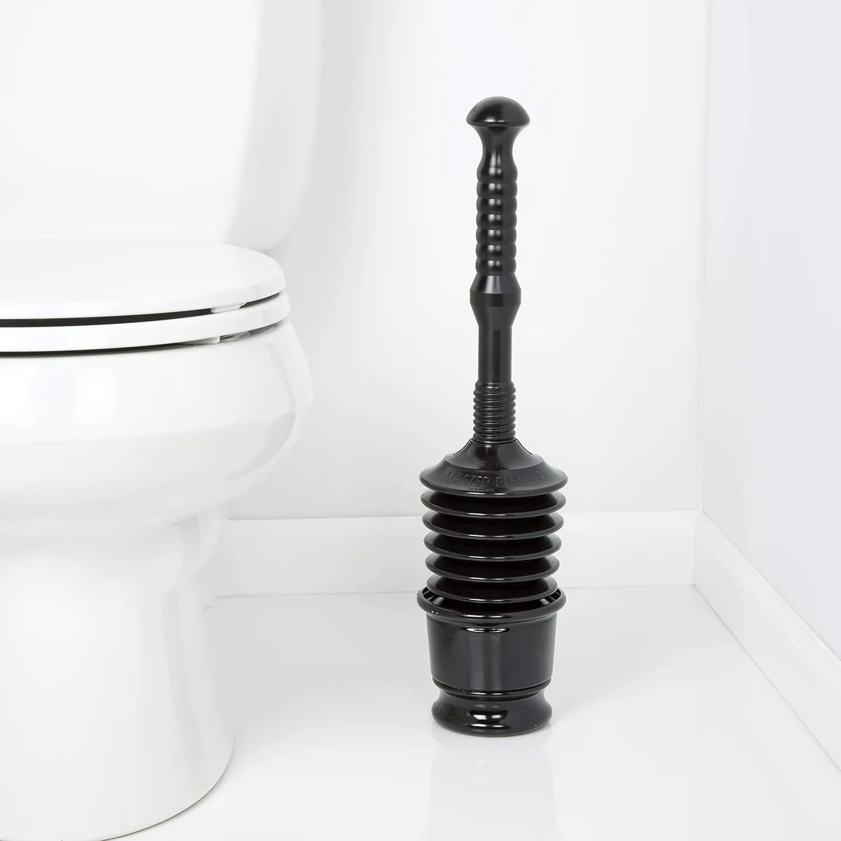 A black Master Plunger 500 standing by a toilet