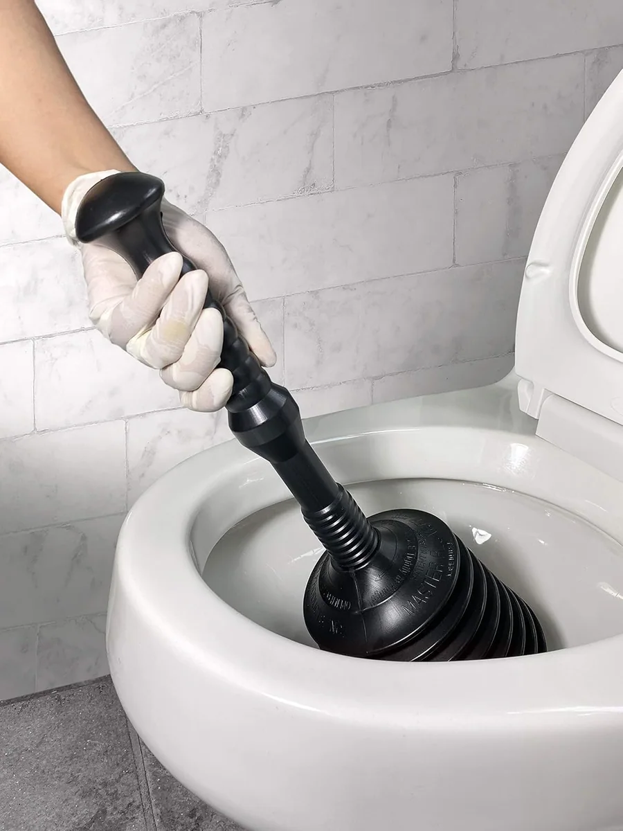 A Master Plunger 100 seated in a toilet bowl